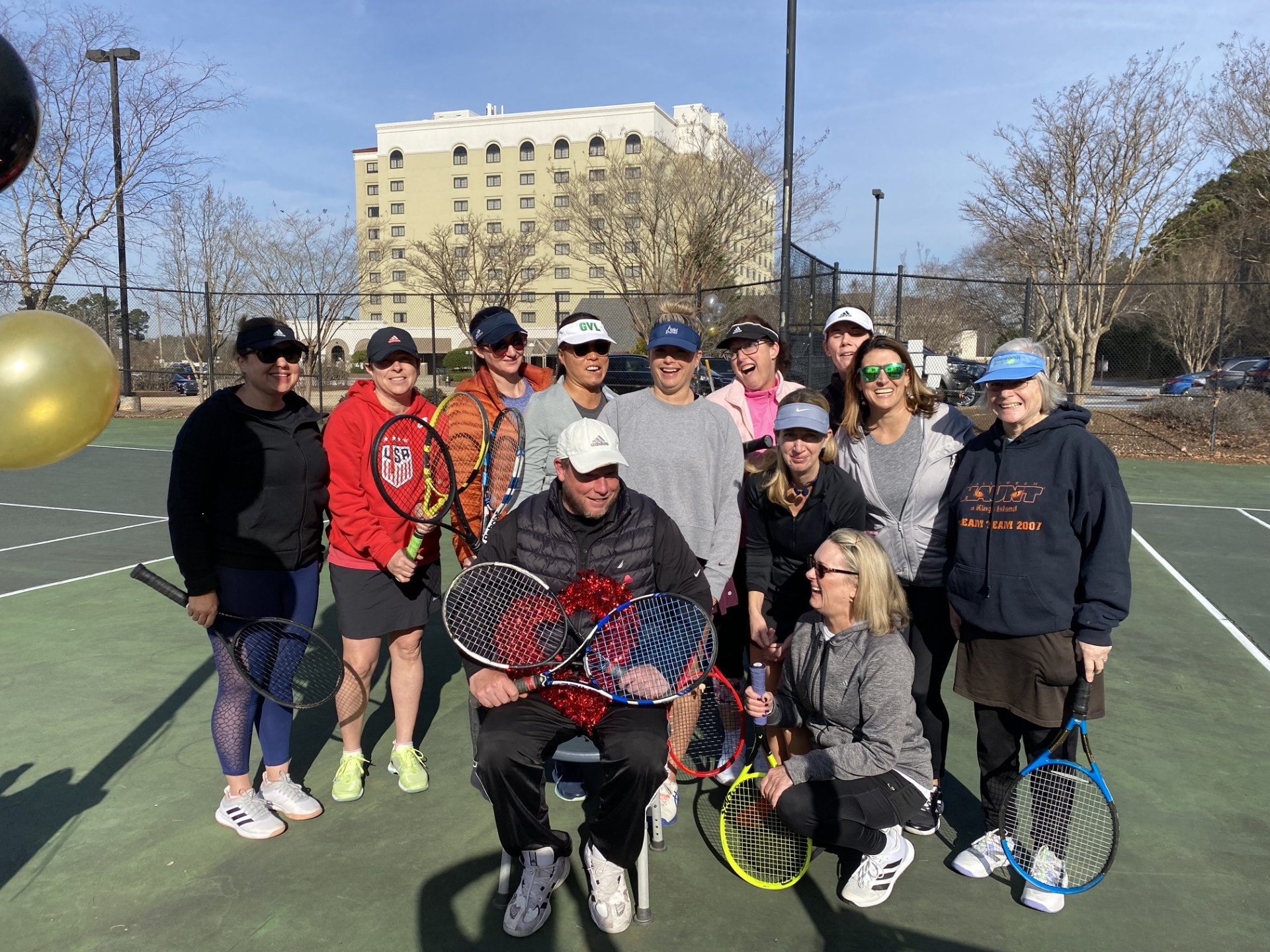 Large group of tennis players posing together on the court at Southside Park